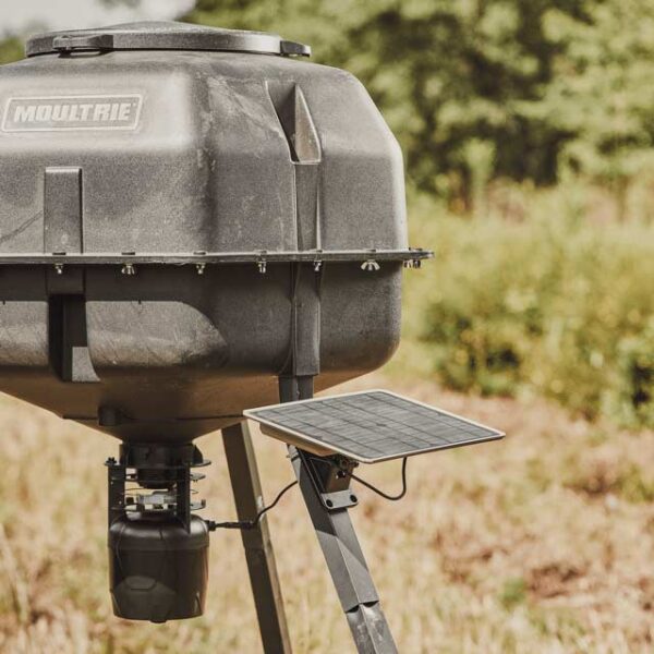 A 10W Solar Power Pack mounted to a Moultrie Feeder in a field.